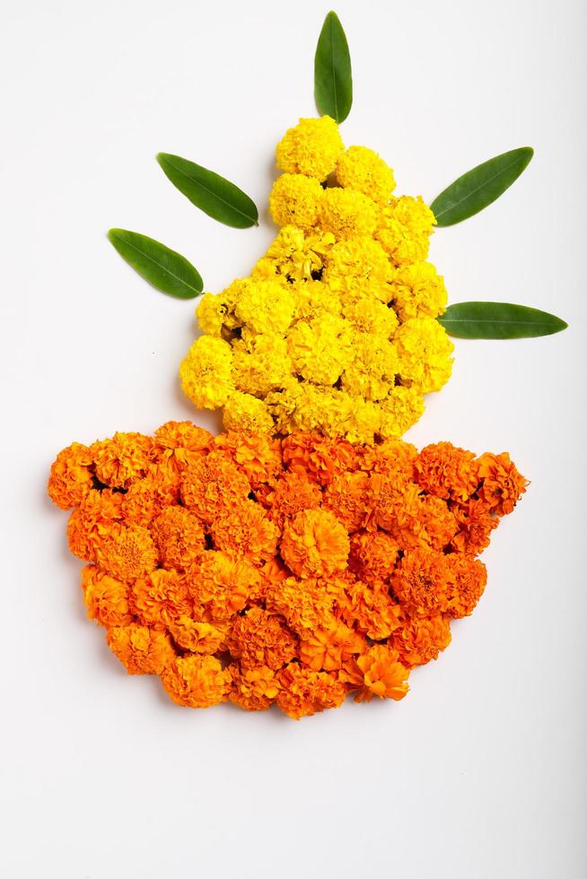 Marigold Flower rangoli Design in oil lamp shape. photo