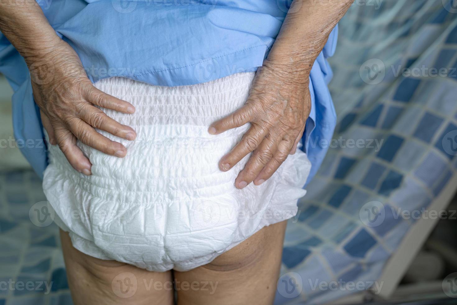 Asian senior or elderly old lady woman patient wearing incontinence diaper in nursing hospital ward, healthy strong medical concept. photo