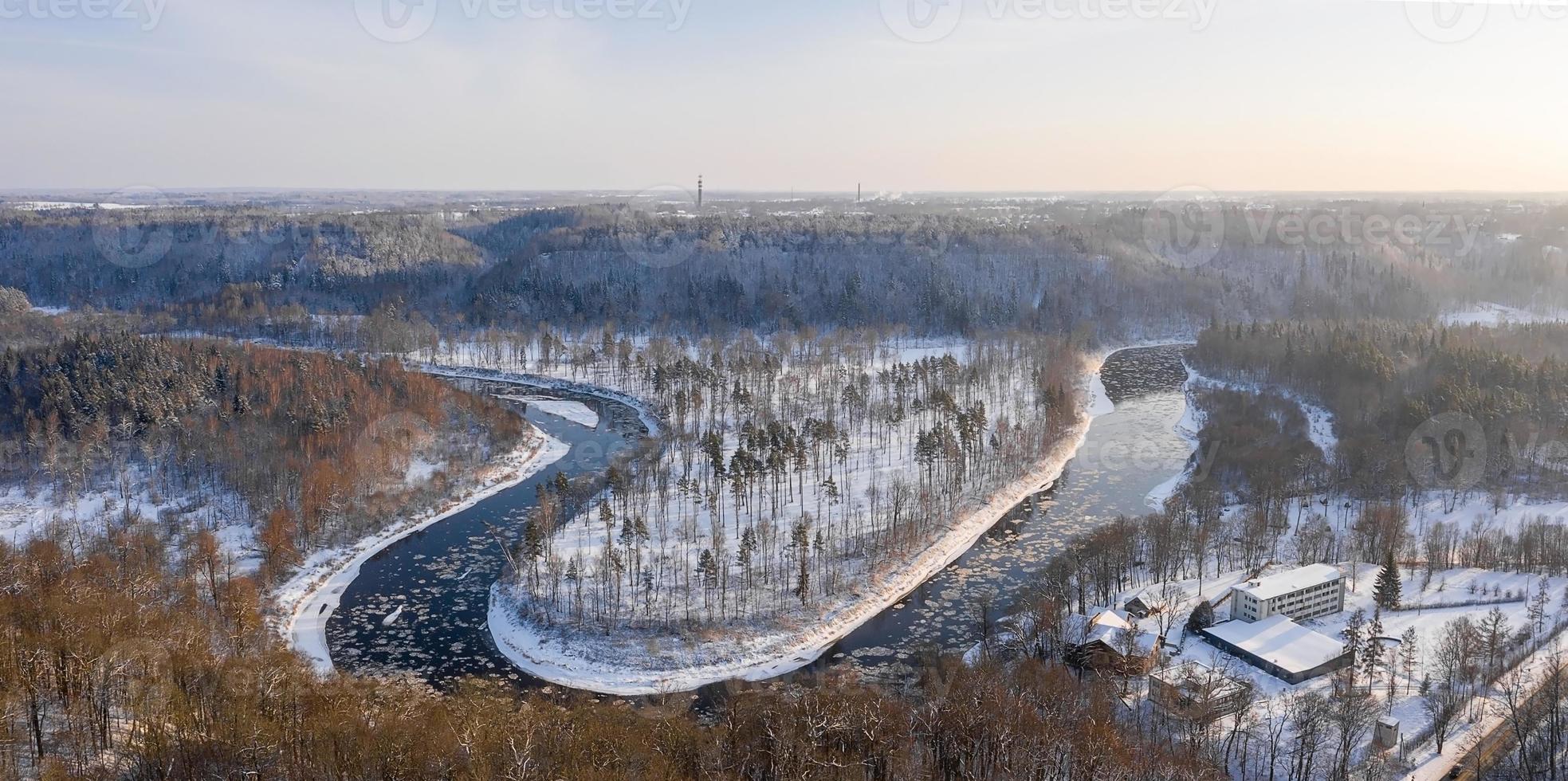 Aerial view of a blue and green river with snow and crushed ice during an ice drift in winter photo
