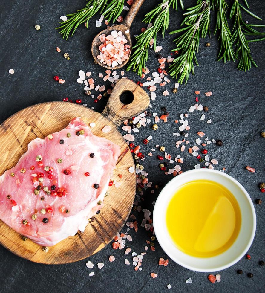 Fresh raw pork chops with spices and herbs photo