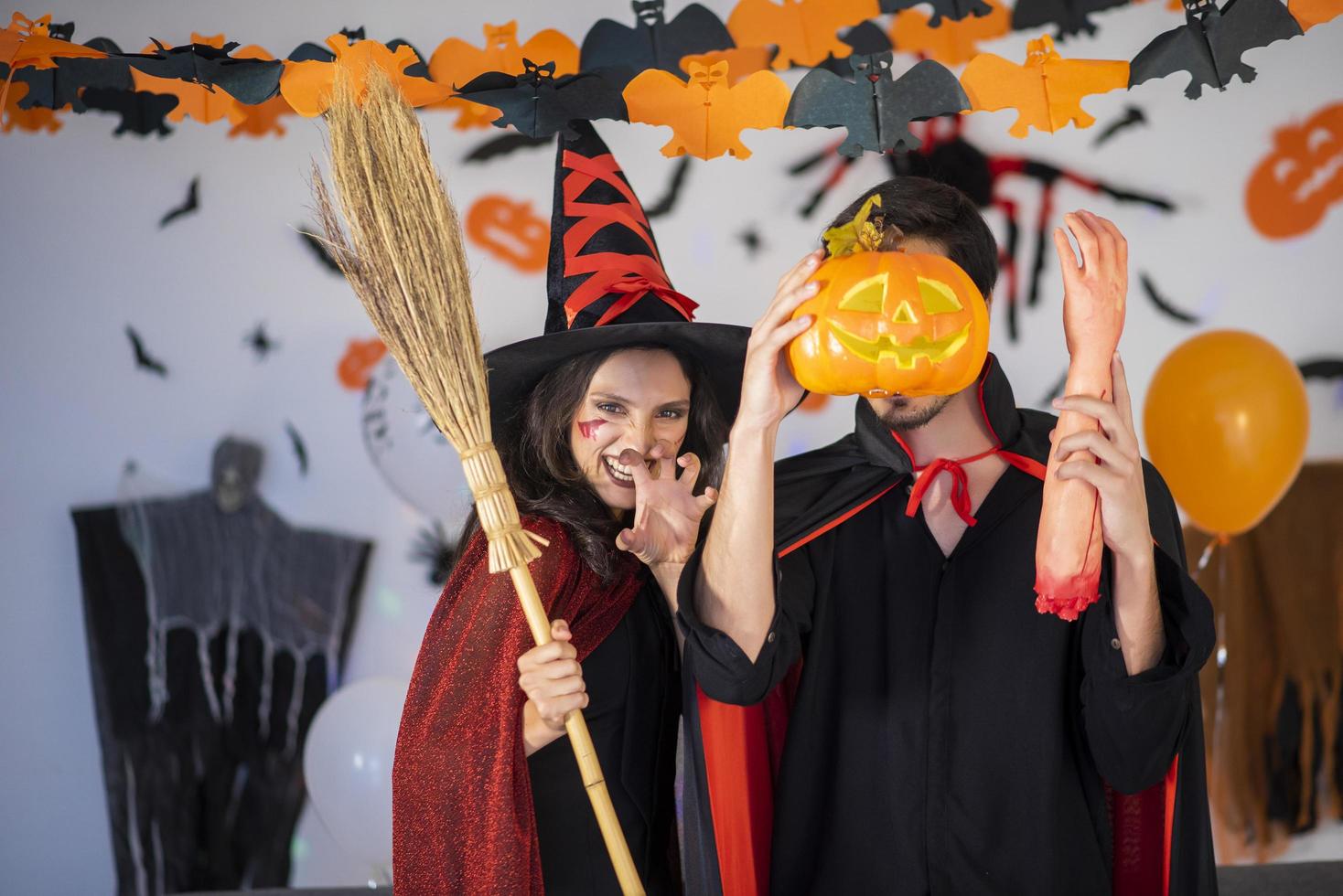 happy couple of love  in costumes and makeup on a celebration of Halloween photo