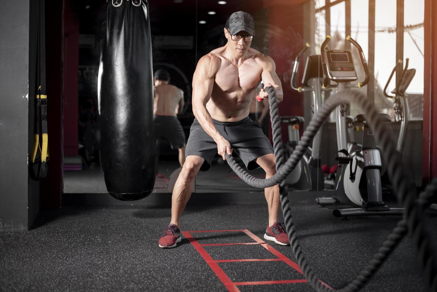 a man is exercise with rope in the gym photo