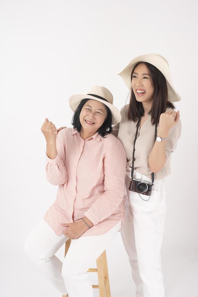 Asian older woman and her daughter on white background, Travel concept photo