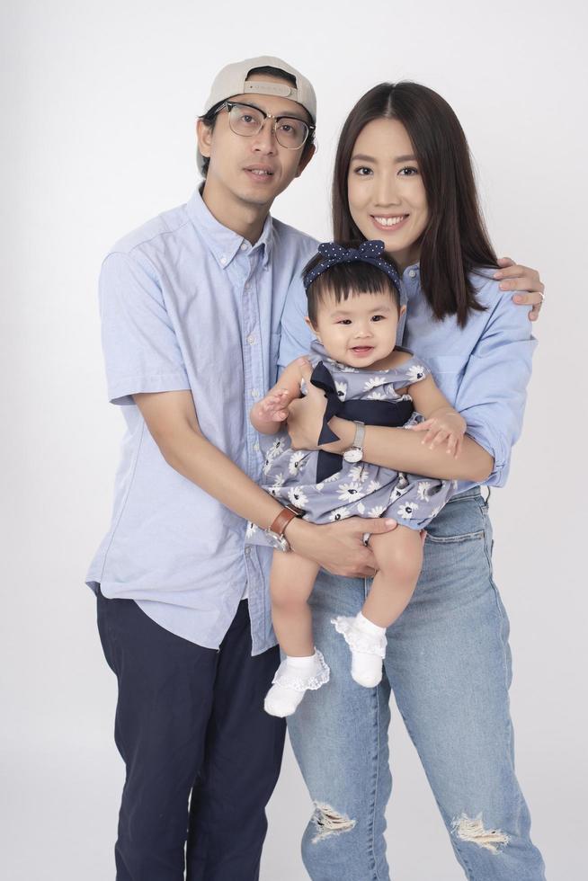 Happy Asian family on white background photo