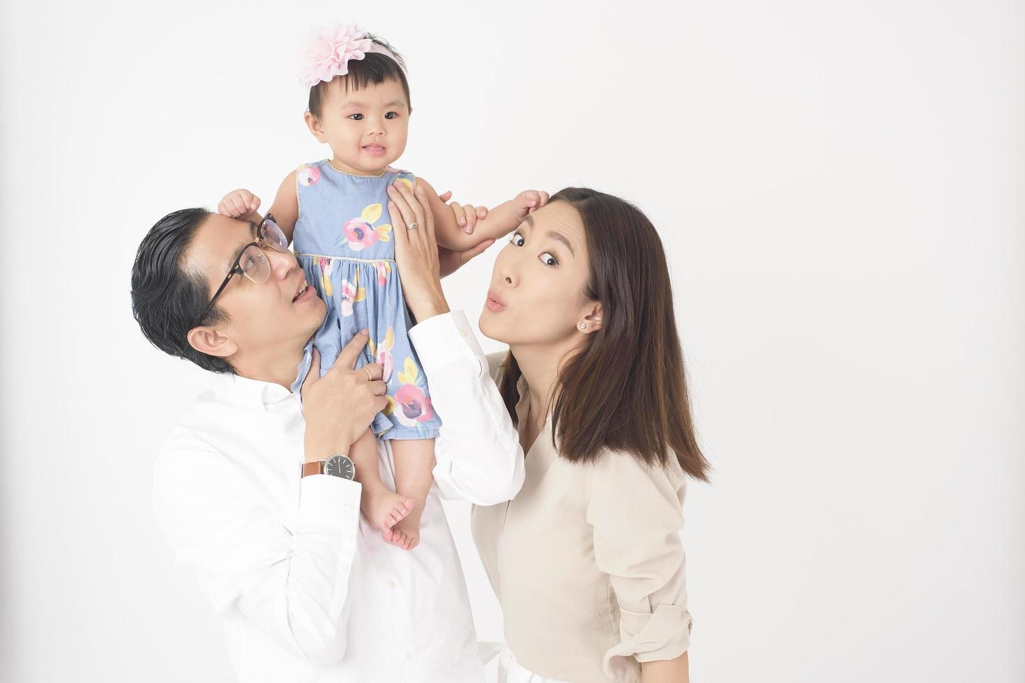 Happy Asian family on white background photo