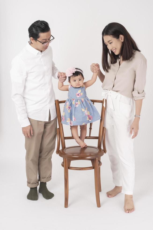 Happy Asian family on white background photo