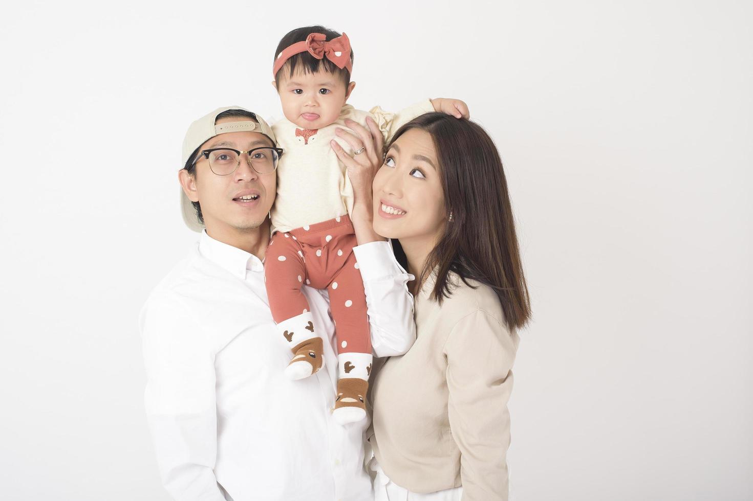 Happy Asian family on white background photo