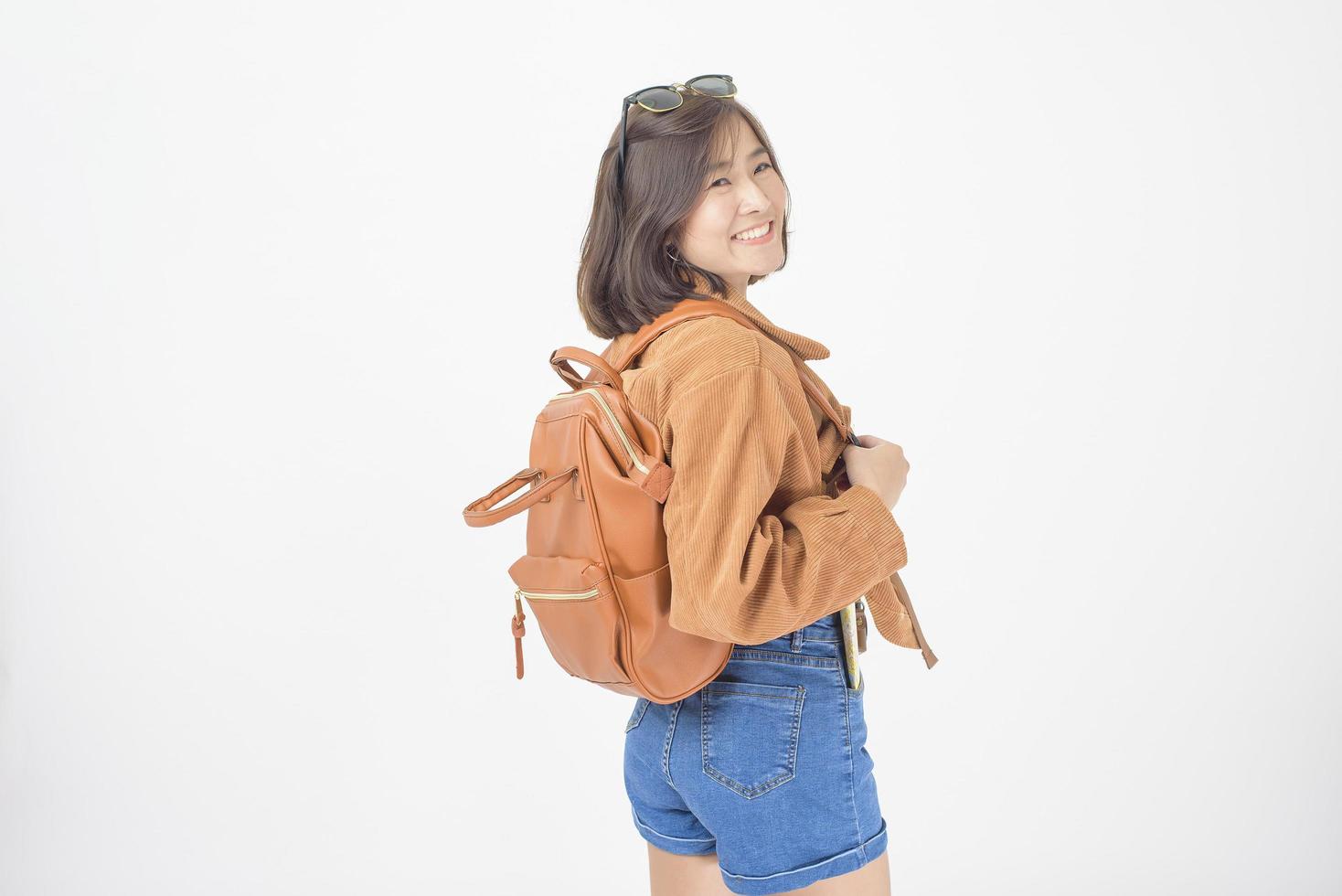 Beautiful young asian tourist woman happy on white background studio photo