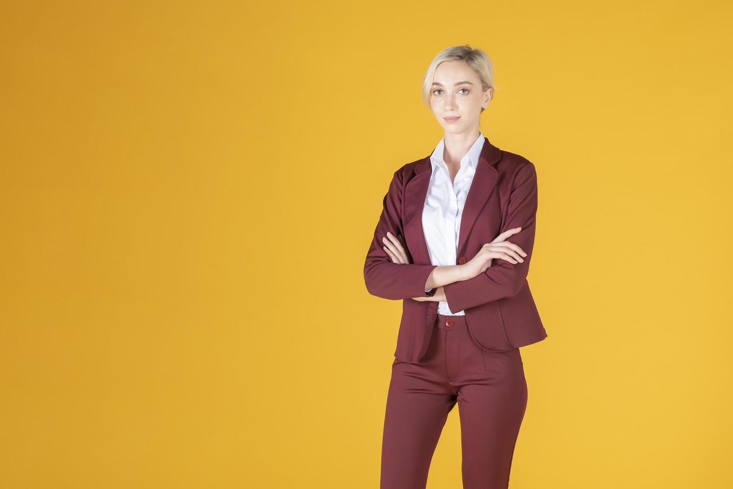 Portrait of confidence caucasian business woman on yellow background photo