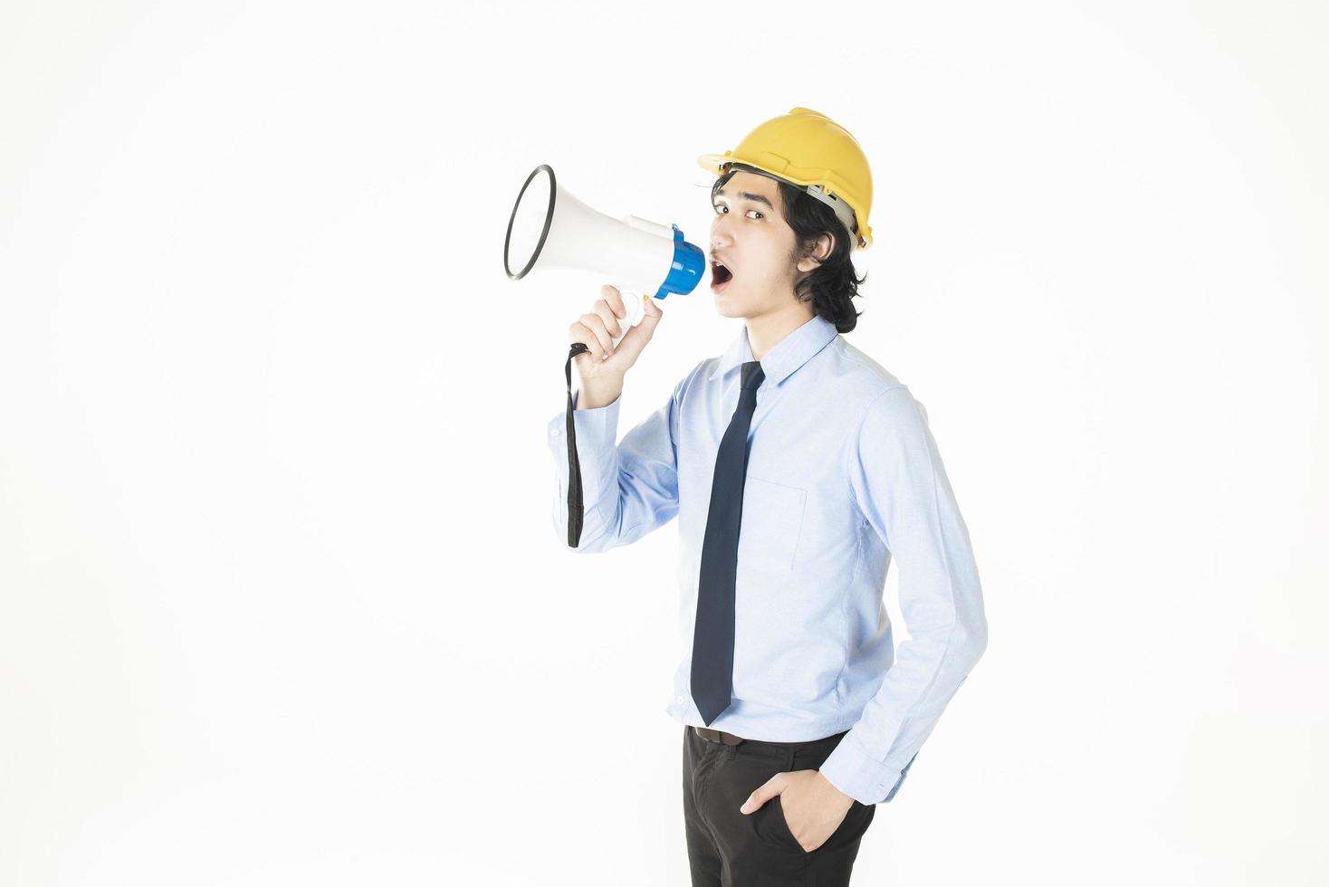 Young engineering man is announcing with megaphone photo