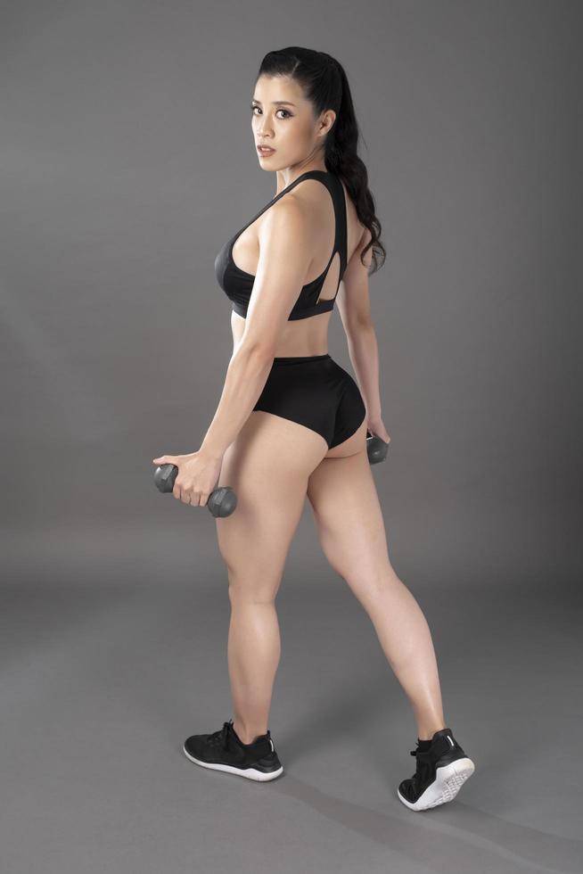 Beautiful fitness body builder woman in Studio photo