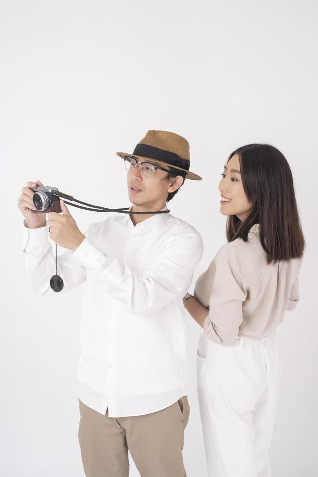 Asian couple tourists are enjoying  on white background photo