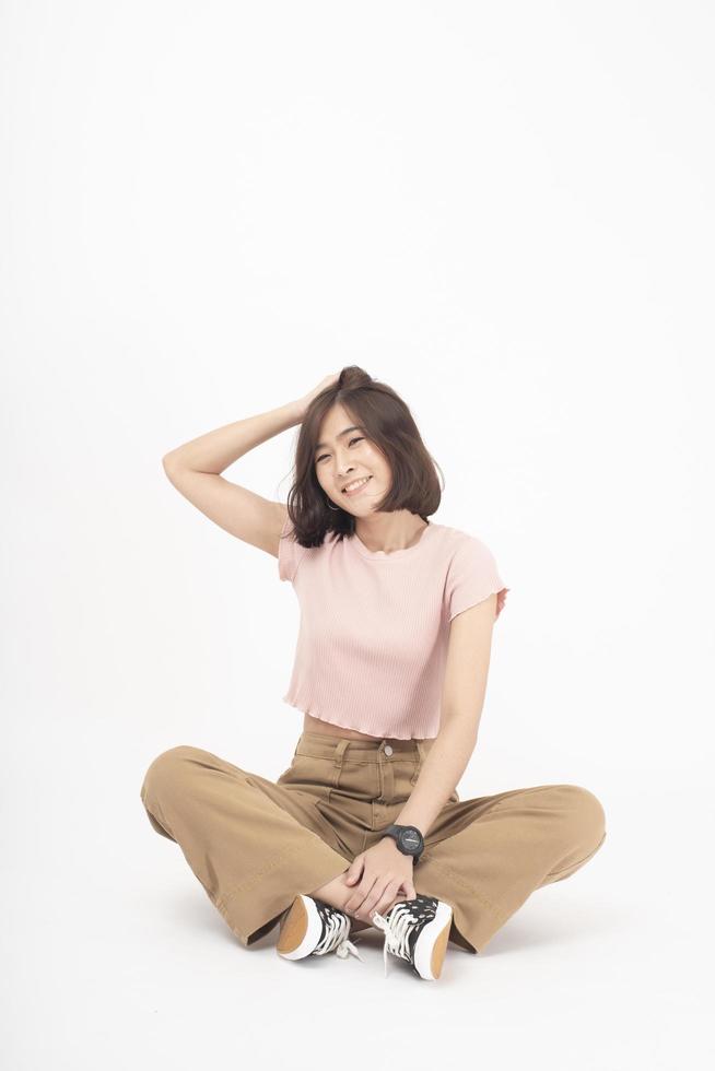 Beautiful happy young Asian woman on white background photo