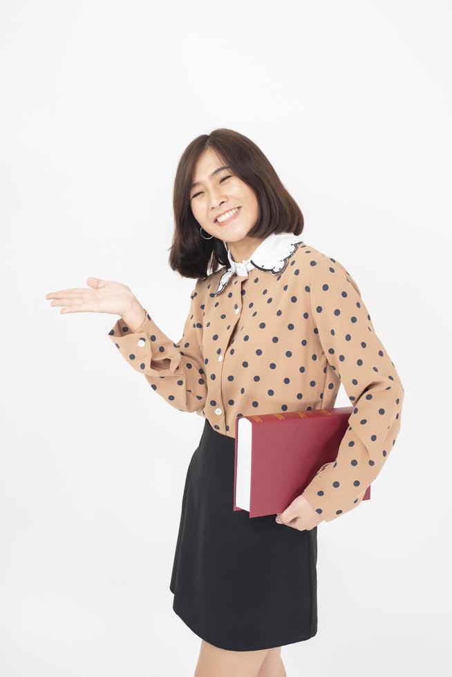 Attractive Asian woman is holding a book on white background photo