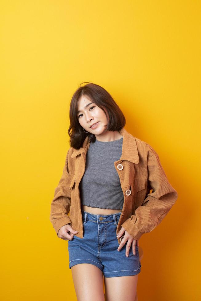 Beautiful asian woman University student happy on yellow background photo