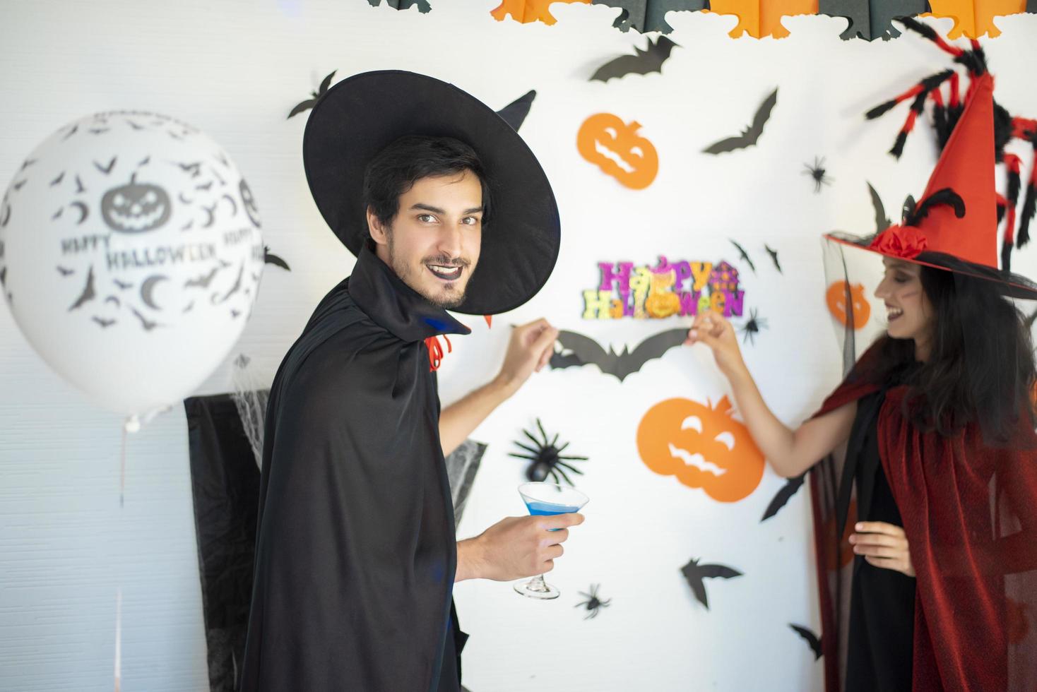 happy couple of love  in costumes and makeup on a celebration of Halloween photo