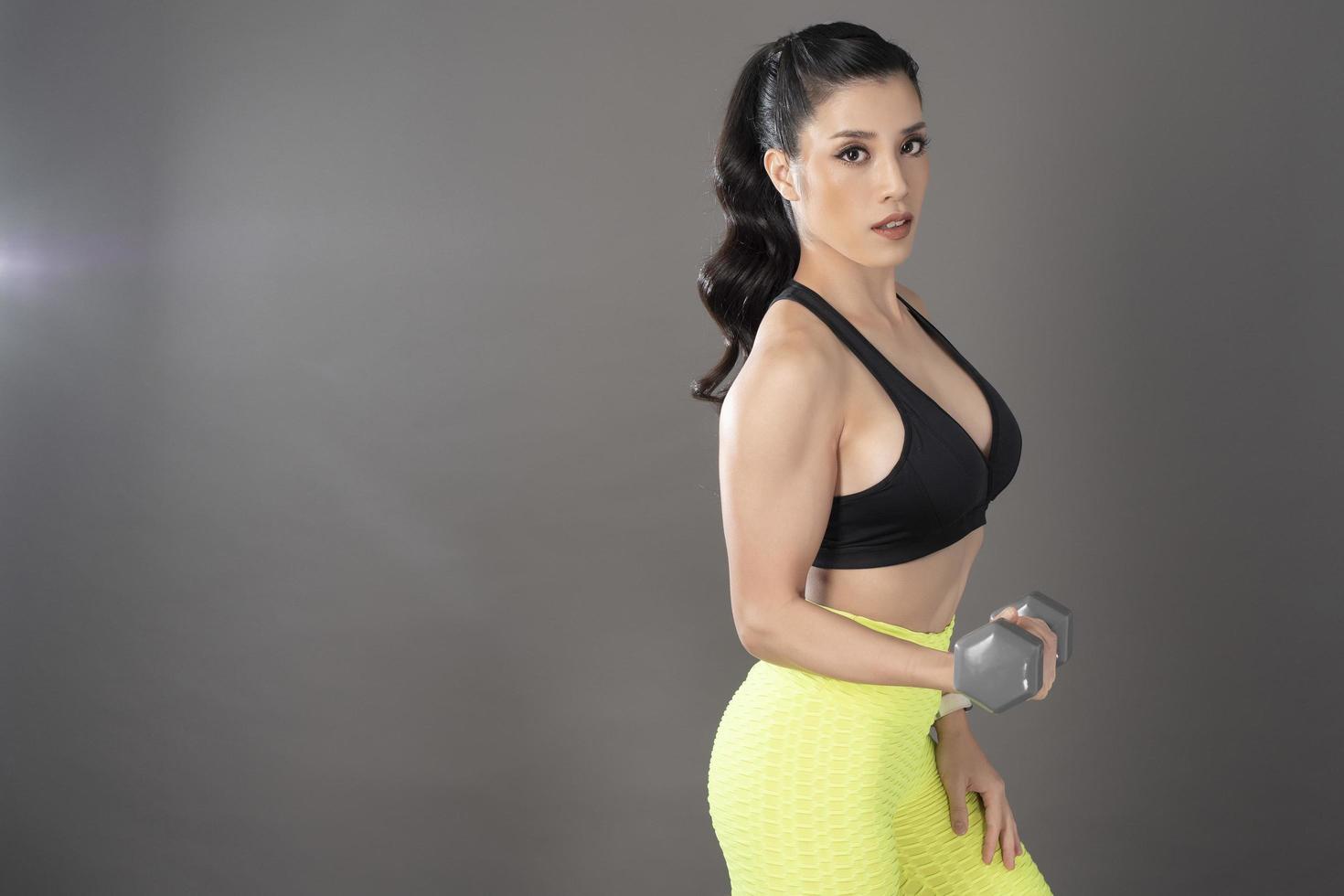 Beautiful fitness body builder woman in Studio photo