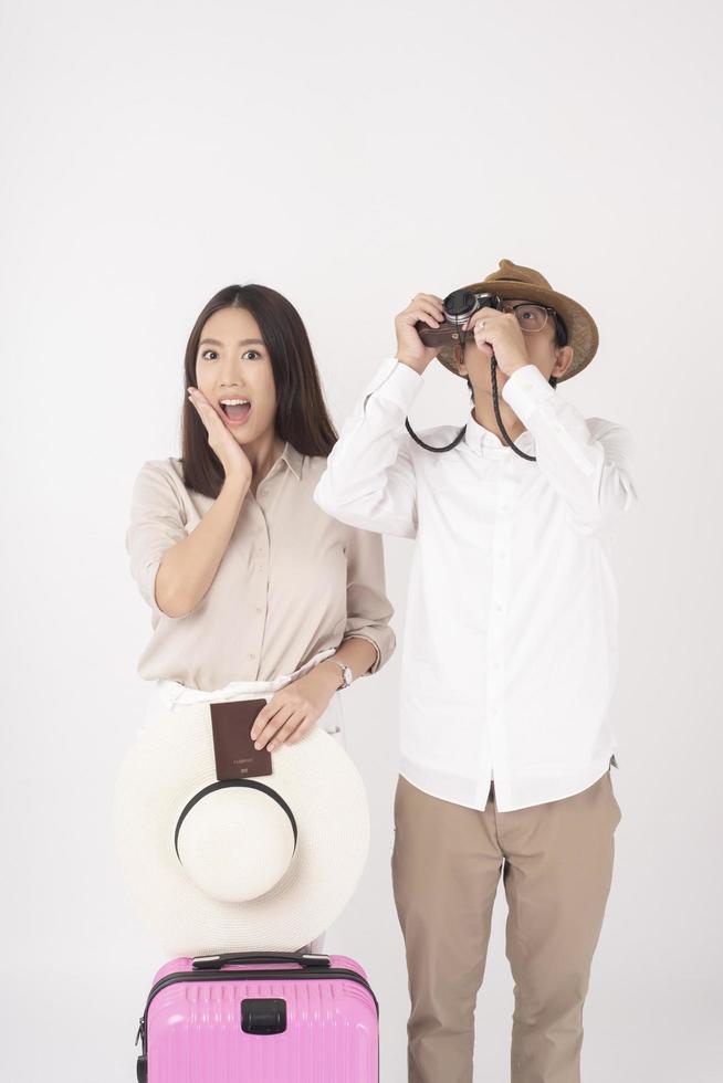 Asian couple tourists are enjoying  on white background photo