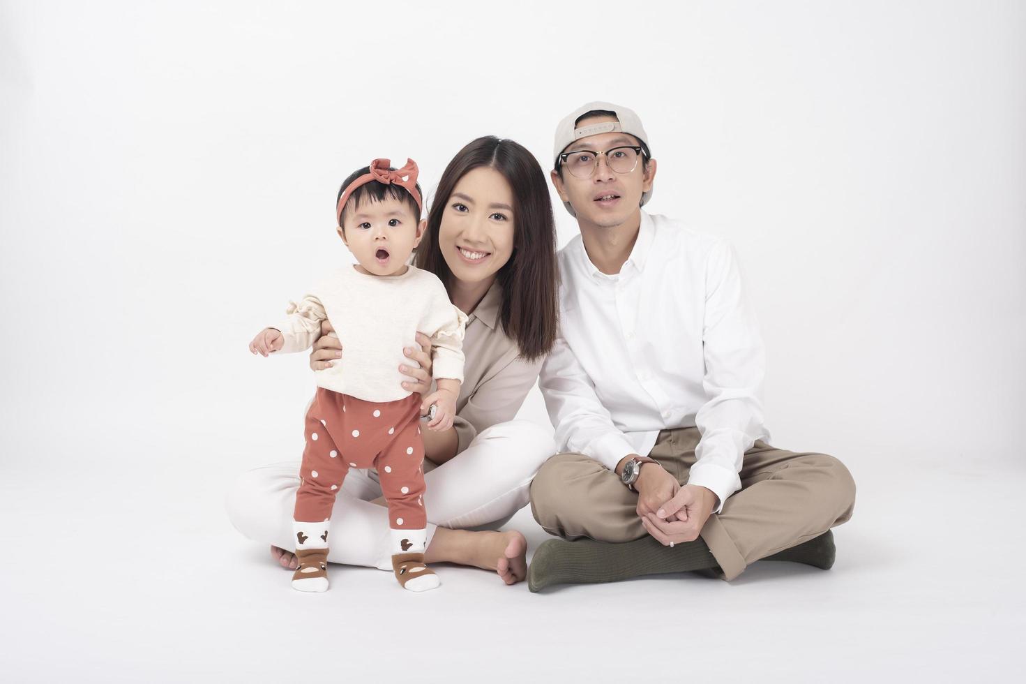 Happy Asian family on white background photo