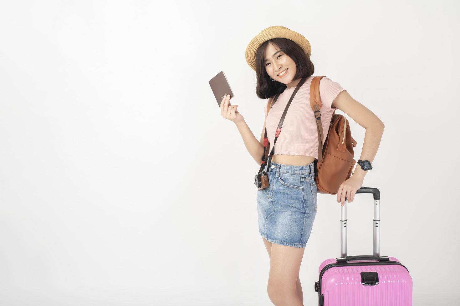 hermosa joven turista asiática feliz en el estudio de fondo blanco foto