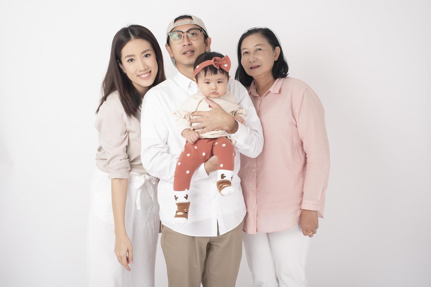 Happy Asian family on white background photo