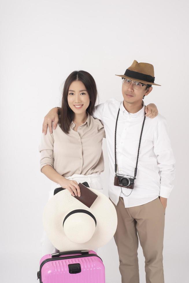 Asian couple tourists are enjoying  on white background photo