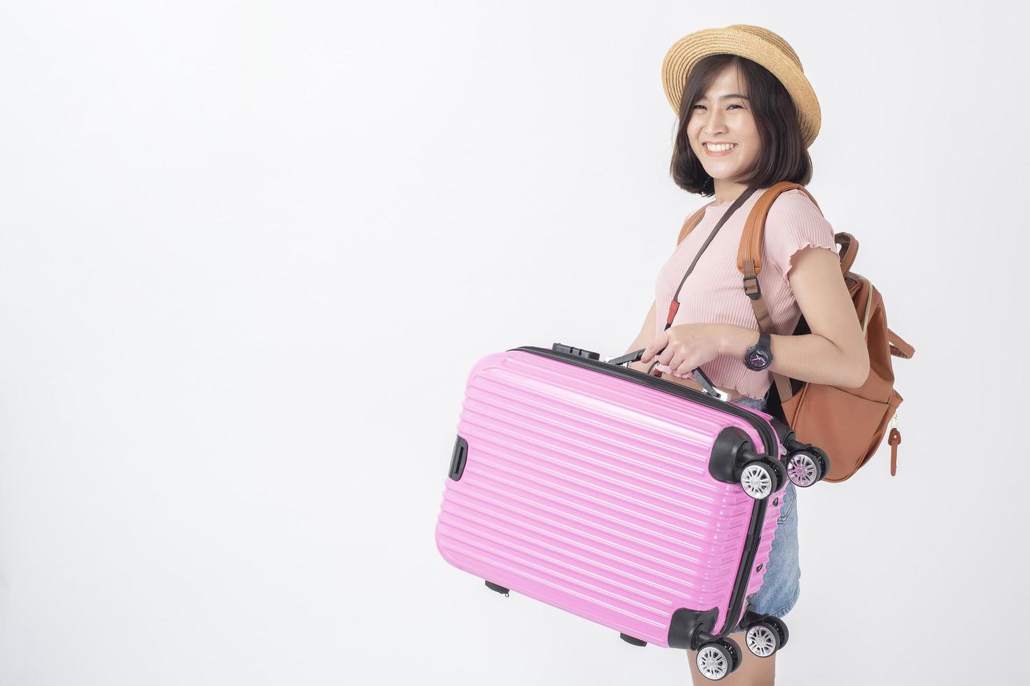 Beautiful young asian tourist woman happy on white background studio photo