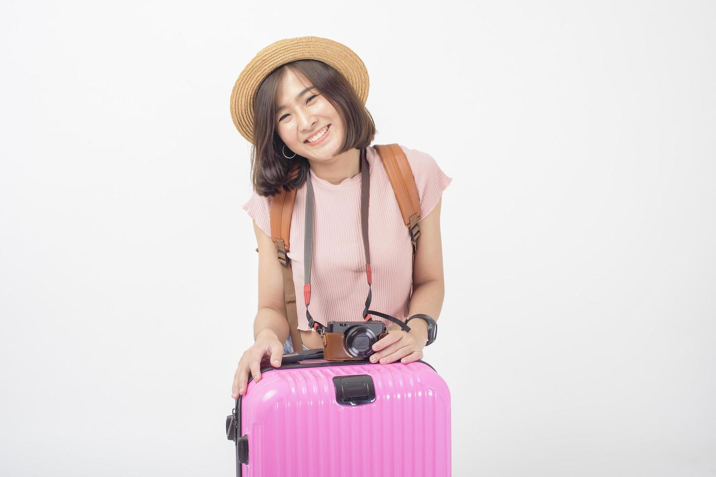 Beautiful young asian tourist woman happy on white background studio photo