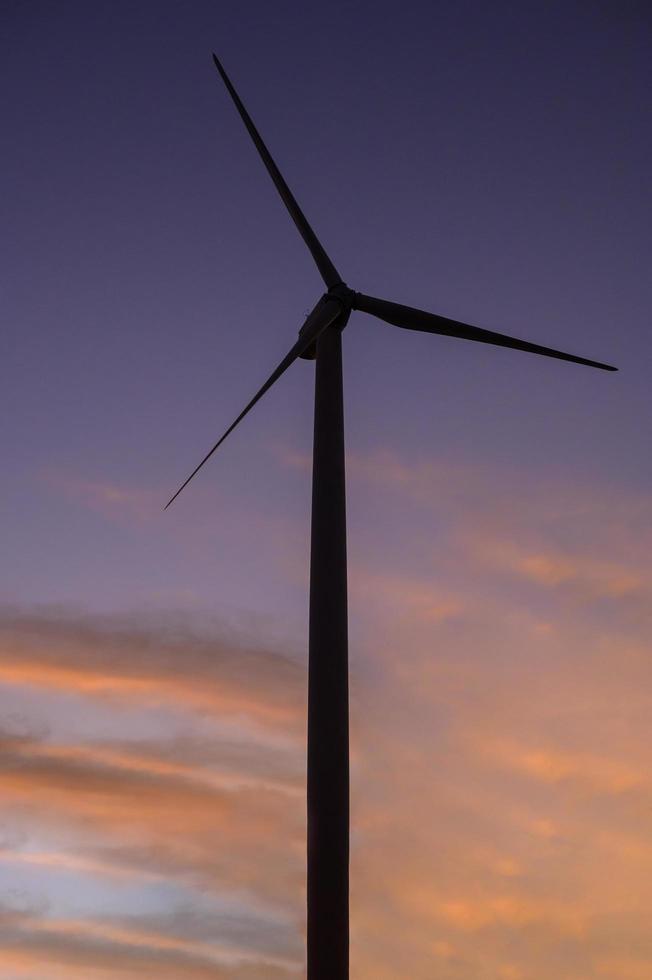 a background of wind turbines  at sunset. photo