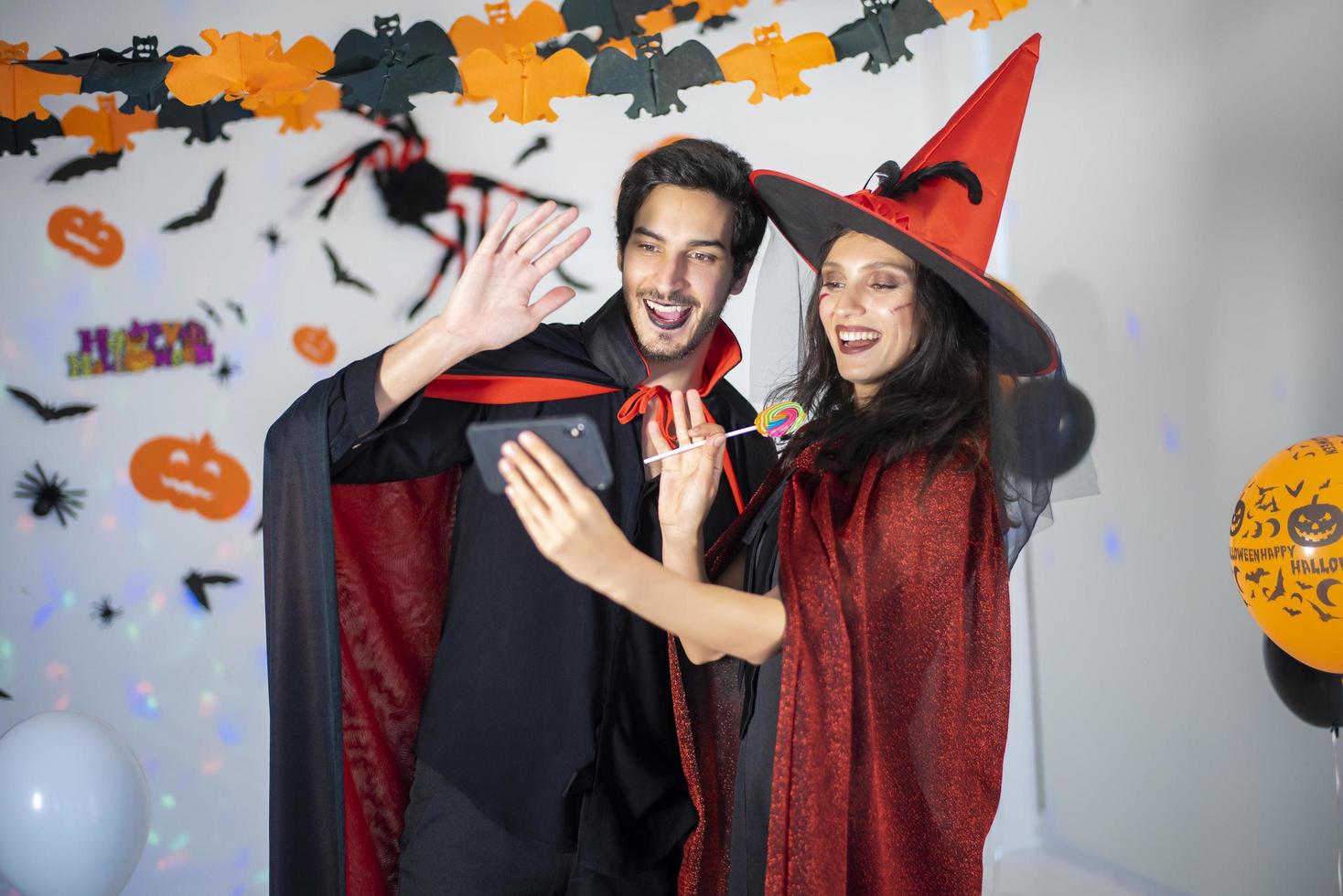 happy couple of love  in costumes and makeup on a celebration of Halloween photo