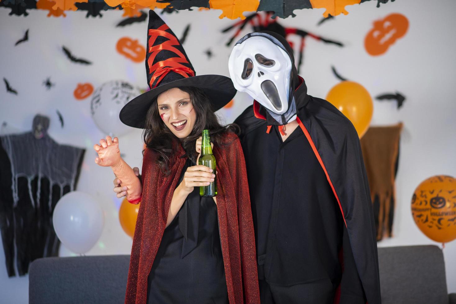 happy couple of love  in costumes and makeup on a celebration of Halloween photo