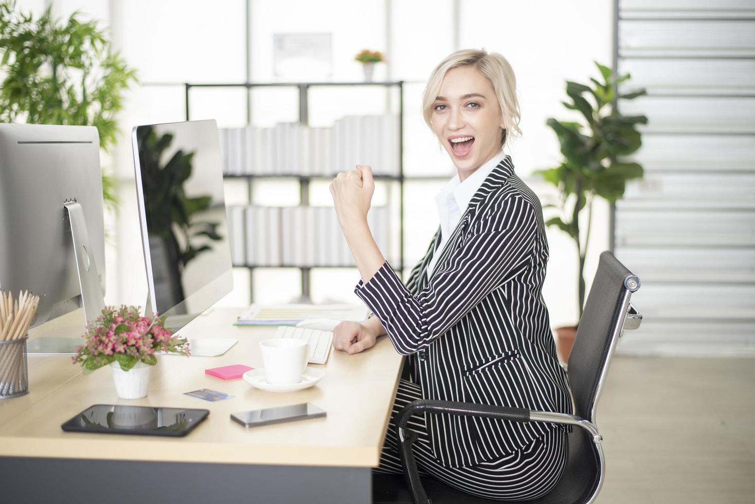 Beautiful Caucasian woman is success in her business plan photo