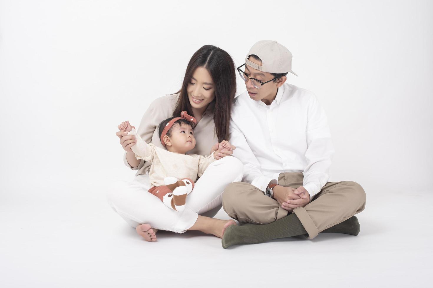 Happy Asian family on white background photo