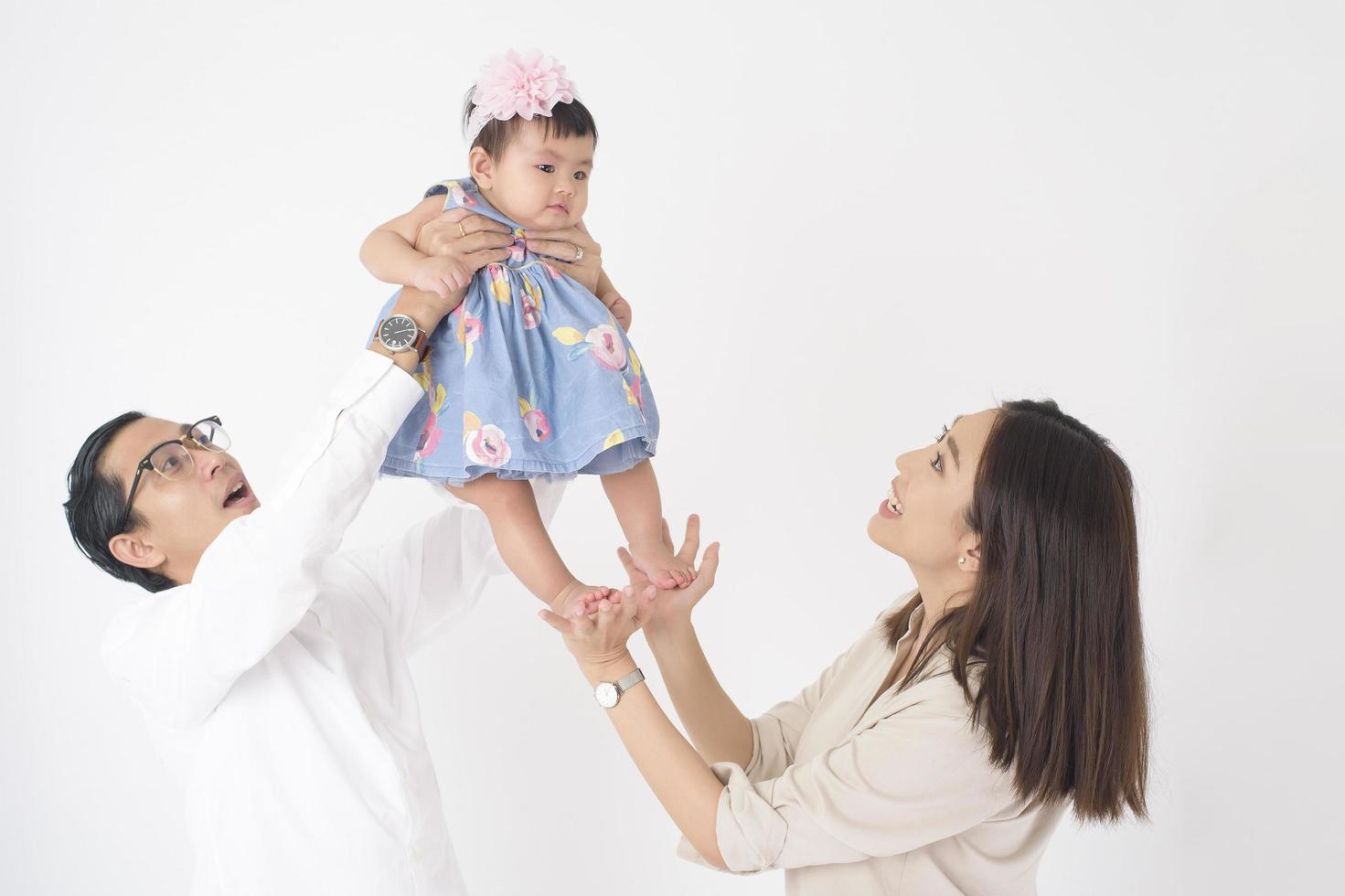 Happy Asian family on white background photo