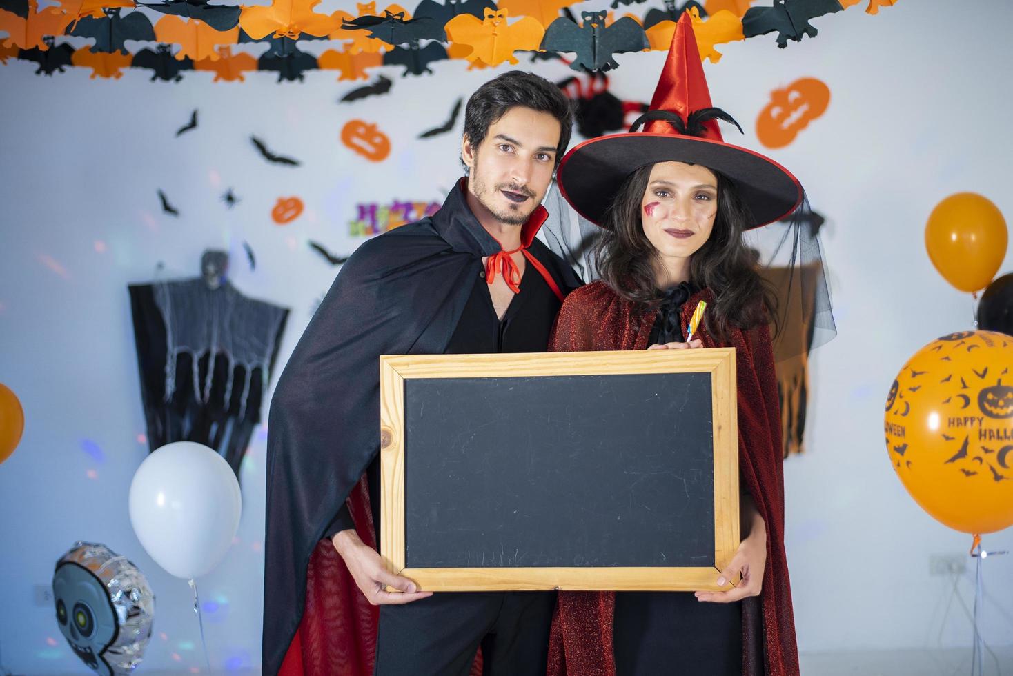 happy couple of love  in costumes and makeup on a celebration of Halloween photo