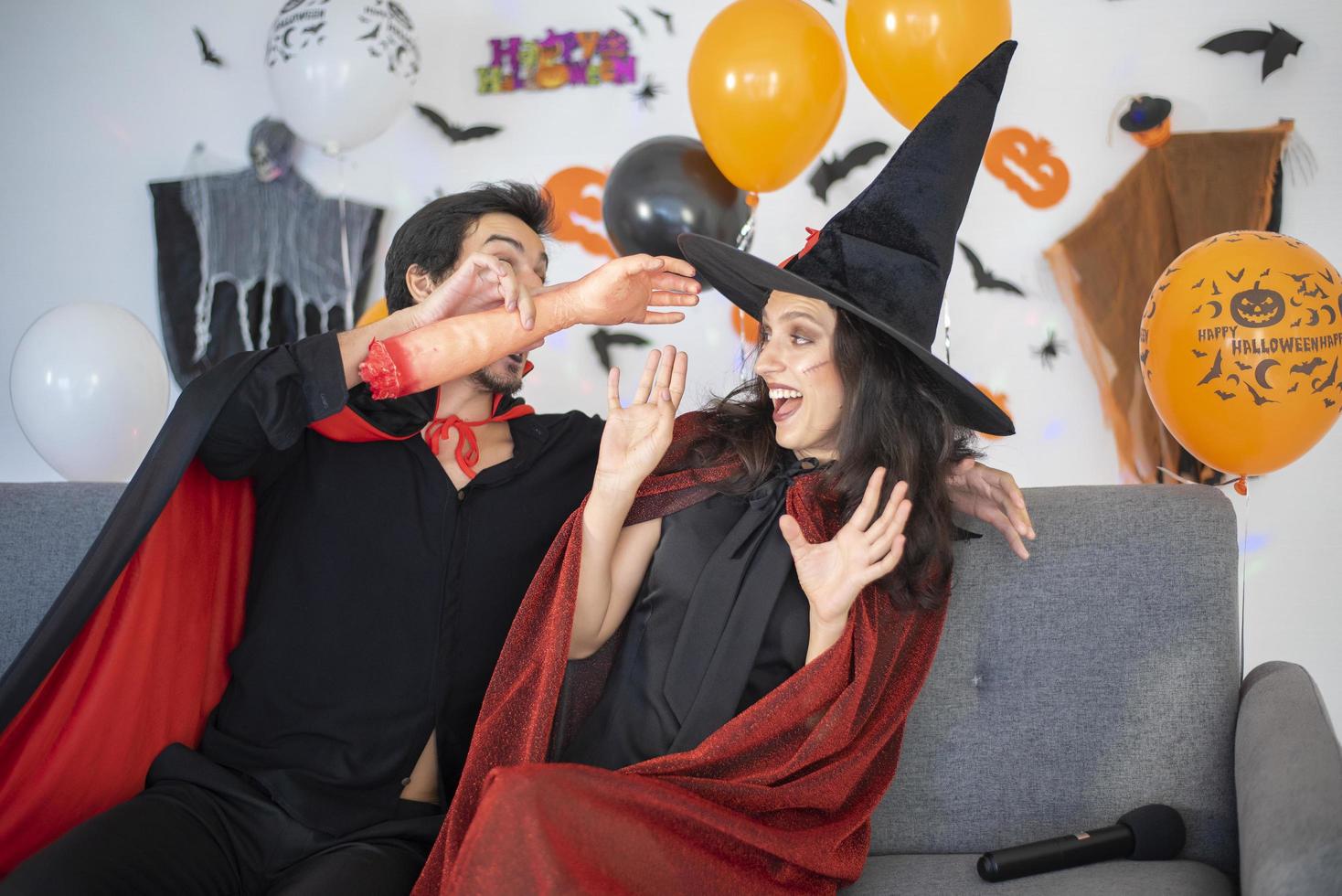 happy couple of love  in costumes and makeup on a celebration of Halloween photo
