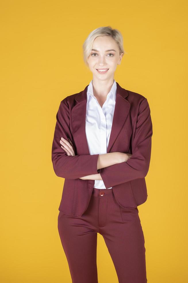 Portrait of confidence caucasian business woman on yellow background photo