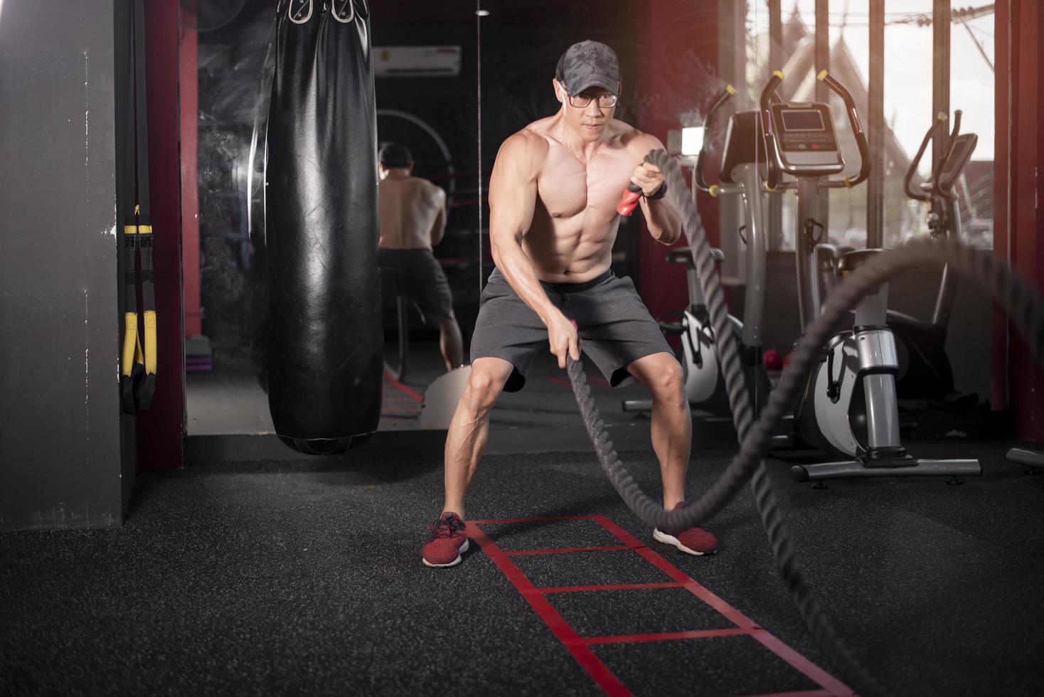 a man is exercise with rope in the gym photo