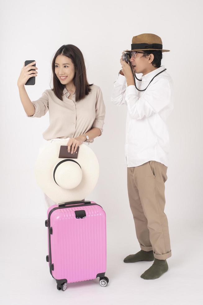 Asian couple tourists are enjoying  on white background photo