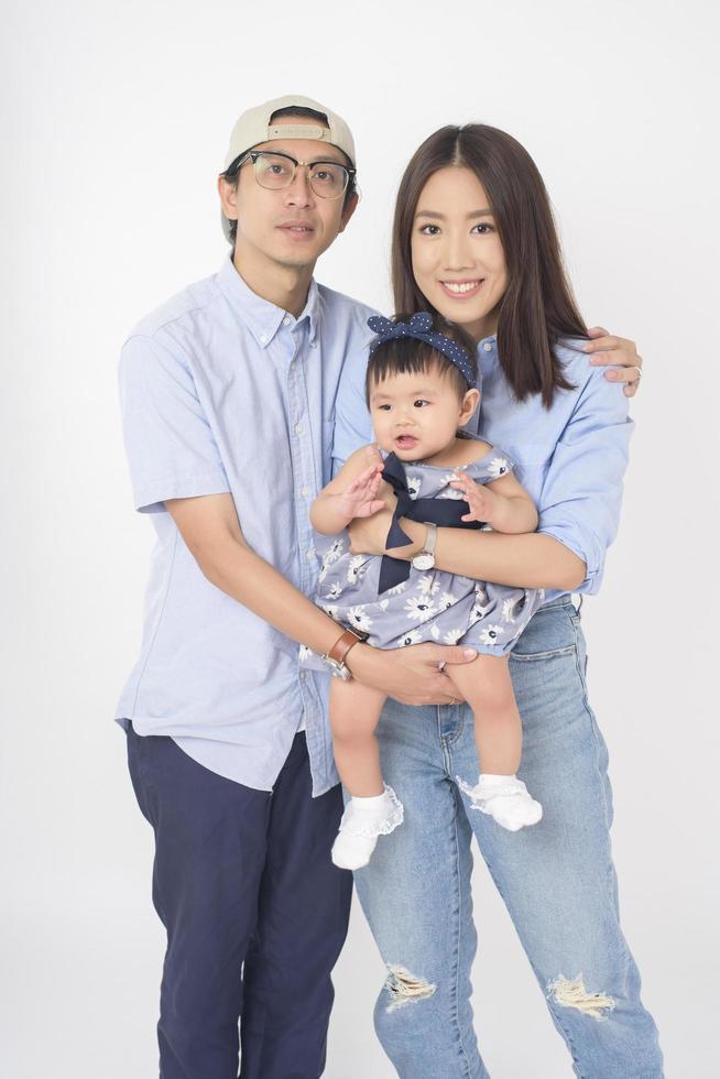 Happy Asian family on white background photo