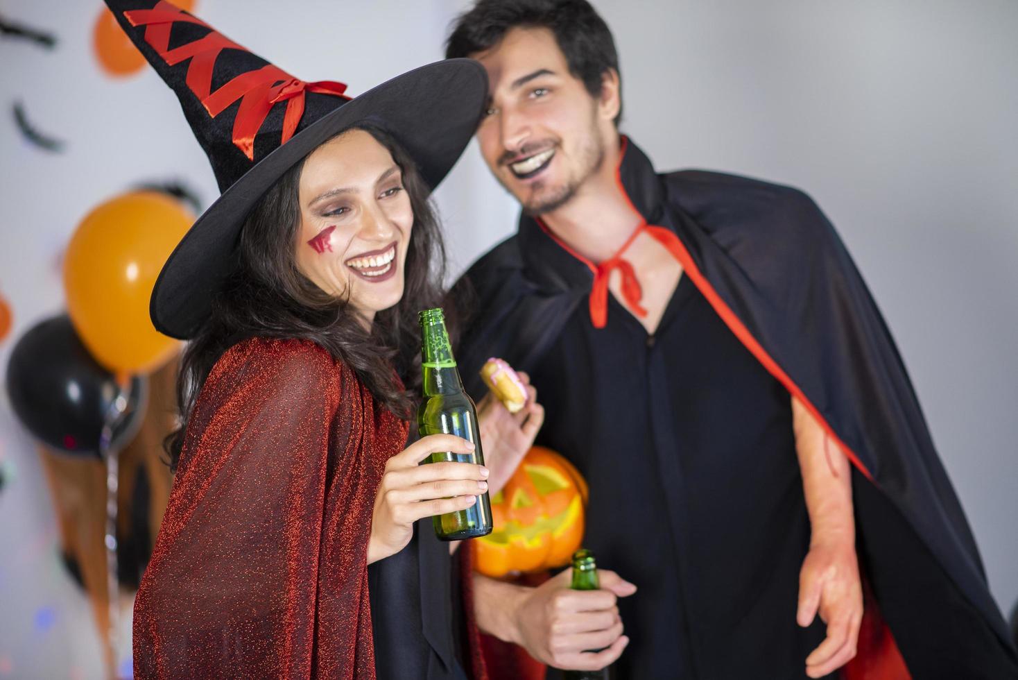 happy couple of love  in costumes and makeup on a celebration of Halloween photo