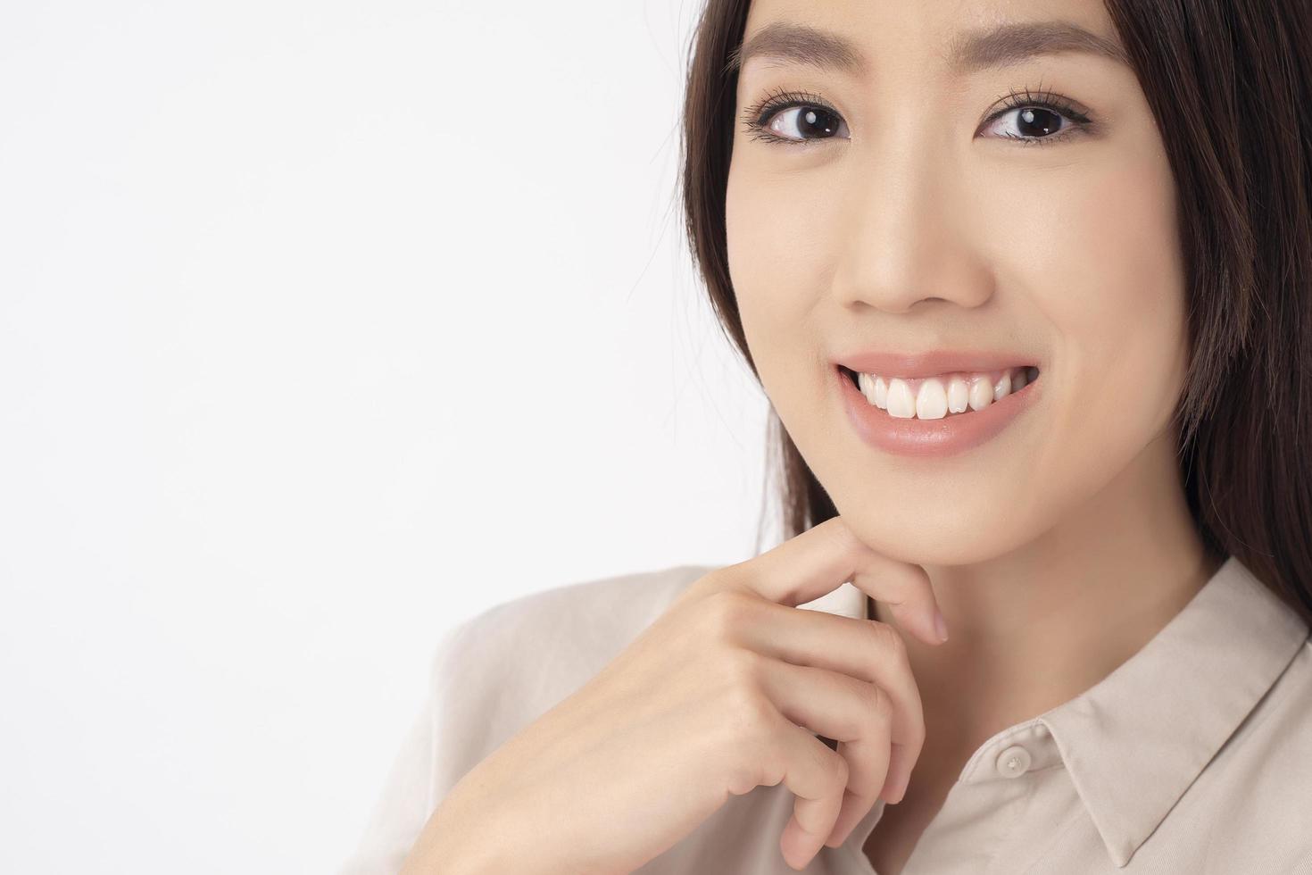 Close up of Asian woman with beautiful teeth on white background photo