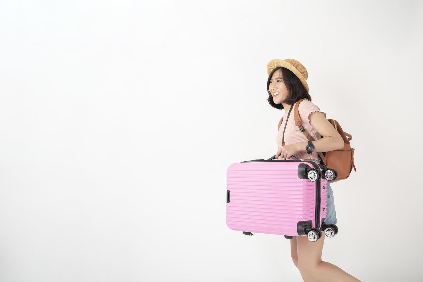 Beautiful young asian tourist woman happy on white background studio photo