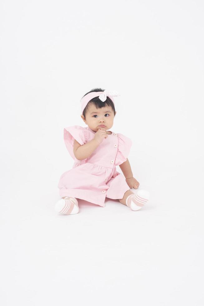 Adorable Asian baby girl is portrait on white background photo