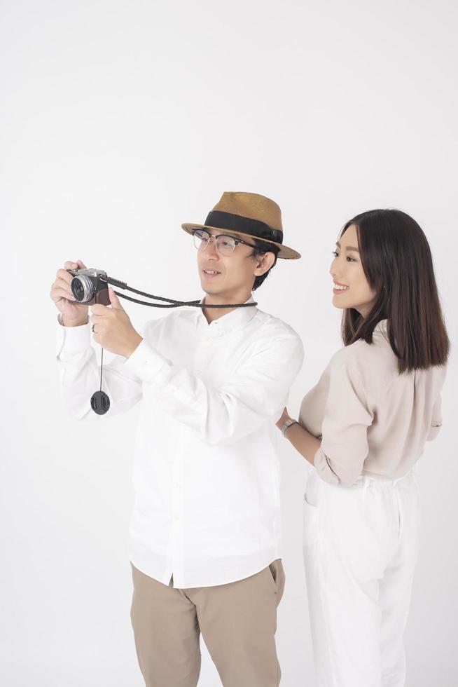 Asian couple tourists are enjoying  on white background photo