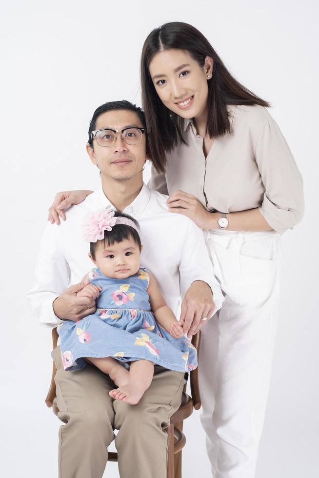 Happy Asian family on white background photo