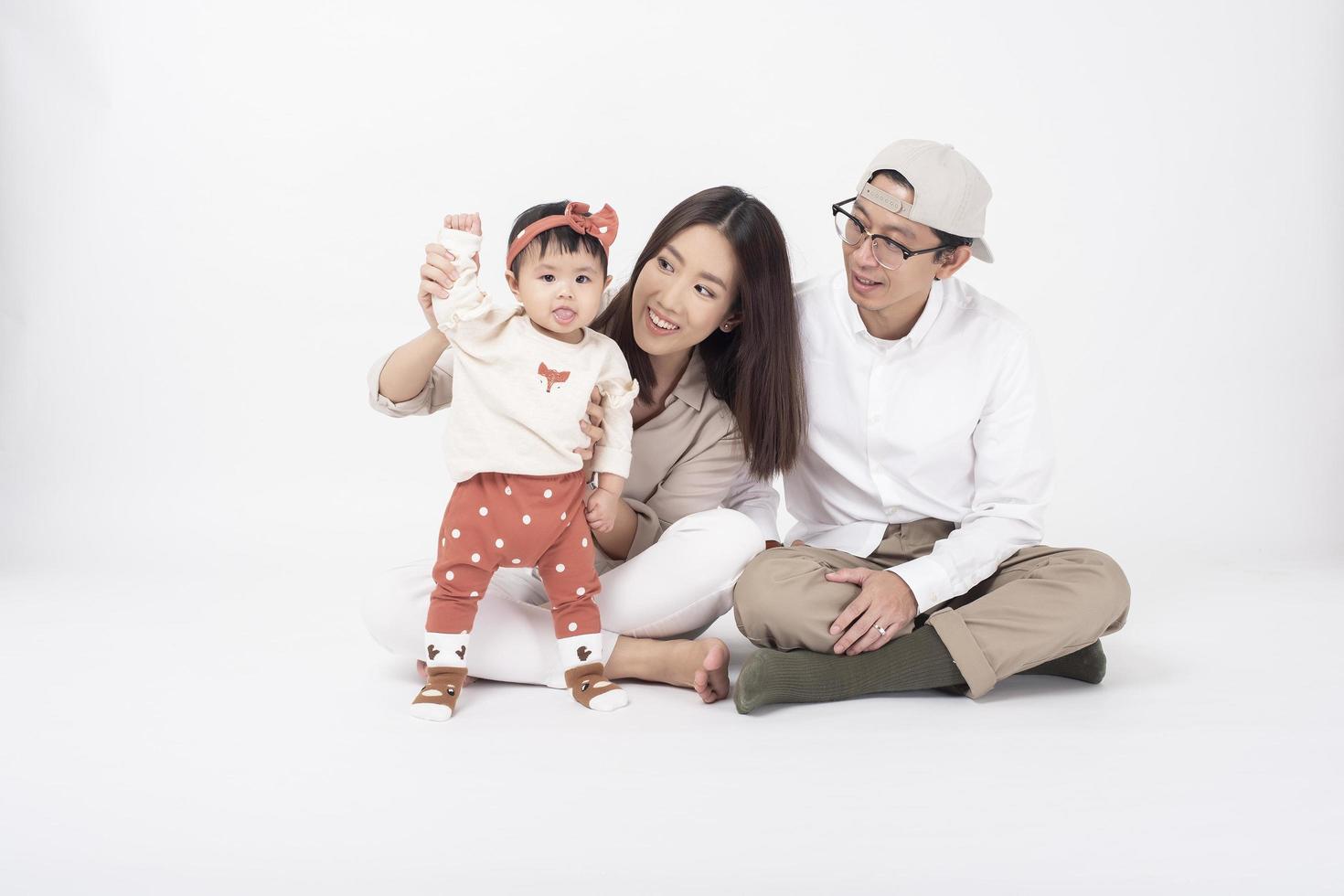 Happy Asian family on white background photo