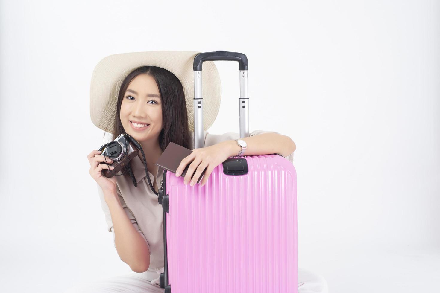 Beautiful Asian woman tourist  on white background photo