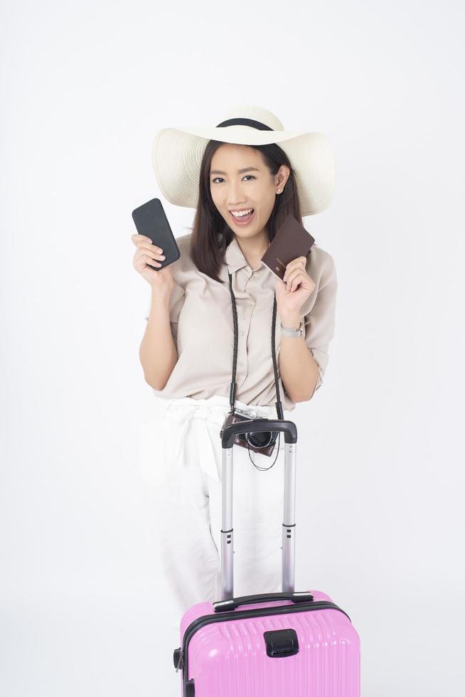 Beautiful Asian woman tourist  on white background photo