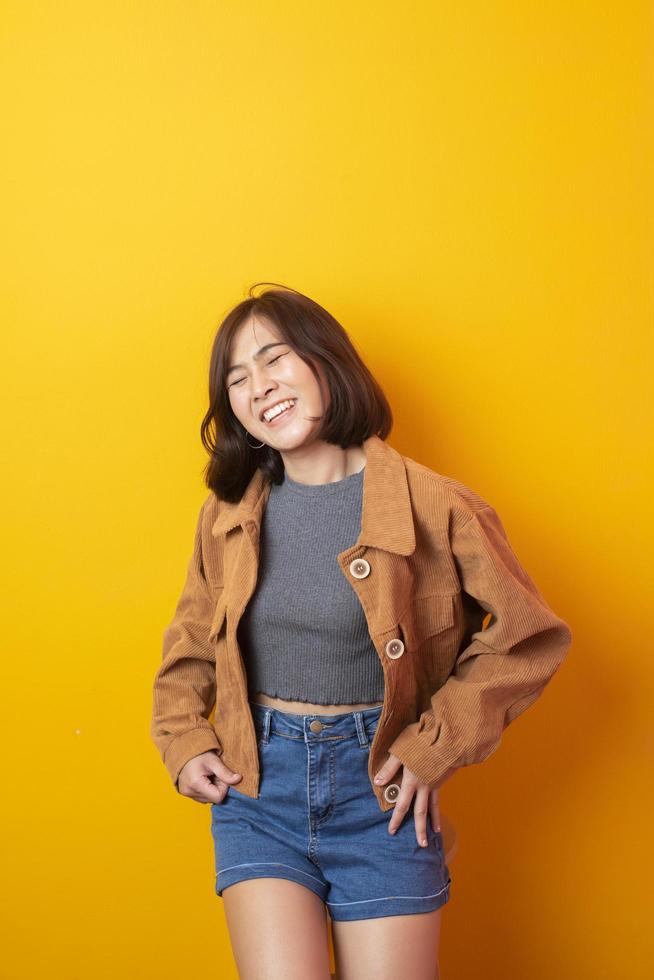 Beautiful asian woman University student happy on yellow background photo